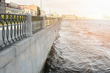 View of The Sinop embankment from the water in the distance you can see Bolsheokhtinsky bridge which is located above the Neva river in St. Petersburg