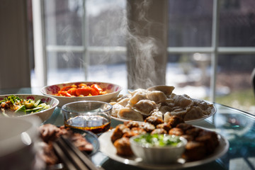 Chinese new year dinner with dumplings and various Chinese dishes