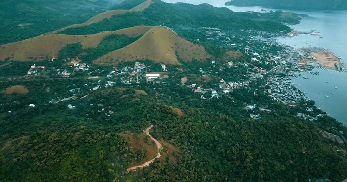 Aerial - drone flying over hill with a cross. Mt. Tapyas, Coron, Palawan, Philippines.