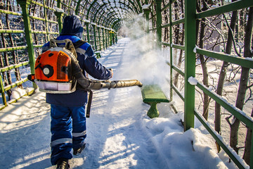 Snow removal. A man blows snow. Winter Park. Winter. Snow removal.
