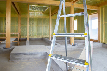 Home construction. Vapor barrier walls. Construction work on the insulation of the house. Carcass home. Skeleton frame covered with palette film.