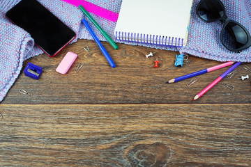 Set of items office mobile notebook sketch pencils markers eraser glasses Wooden dark background...