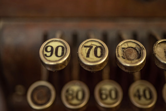 Old technology worn out number keys on vintage cash register machine