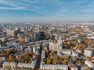 Fototapeta premium Aerial drone shot of Voronezh downtown with buildings from above, parks, streets with cars in sunny autumn day
