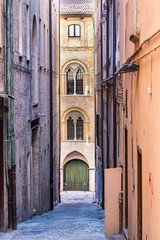 The Via degli Aranci, a narrow - alleway street with old bricks walls in the city center of Ancona, Italy.
