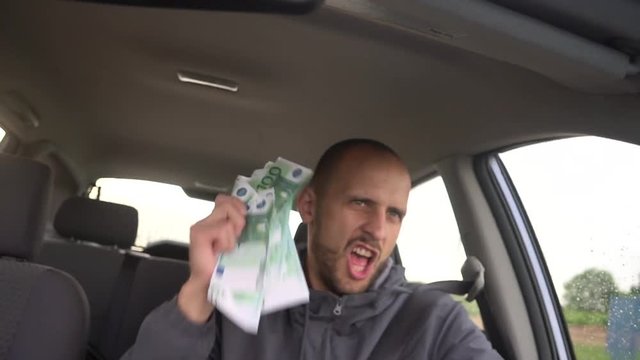 Happy driver with big money euro. Success. Concept on the business success, topic of lottery, winnings, slot machines.