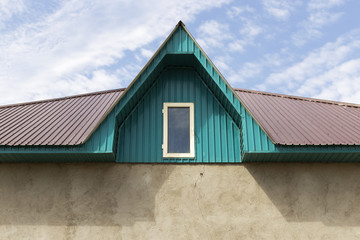 Roof of a house on a blue sky background