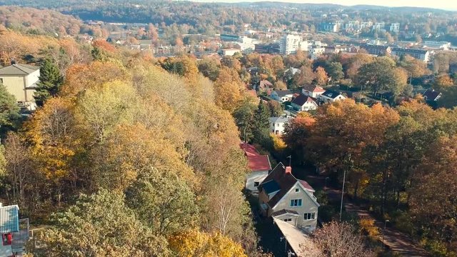 Flying drone to show a neighborhood in the autum.