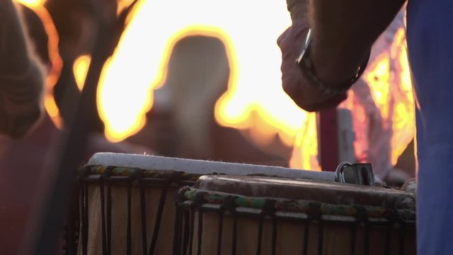 Slow Motion close up of stick hitting drum in sunset light at the drum circle at Siesta Key Beach