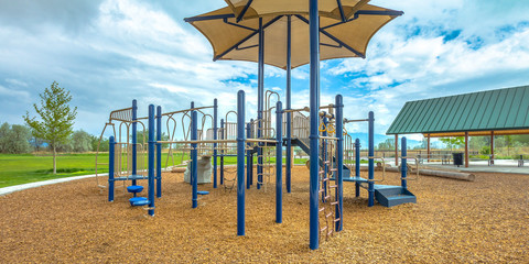 Fototapeta premium Childrens playground under cloudy sky in Lehi Utah