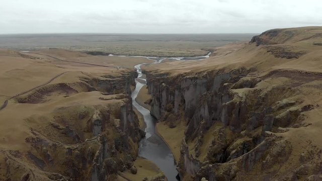 Cinematic aerial flyover of stunning Icelandic canyon.