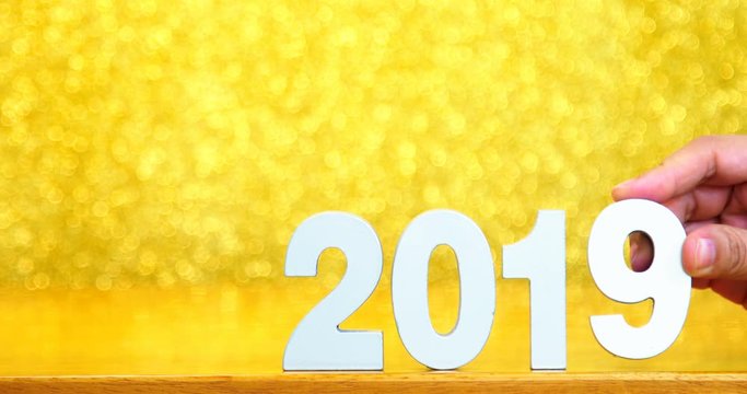 Woman hand replace number 2018 and put number 2019 for happy new year