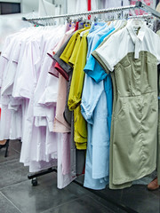 White and colored medical robes on hangers 