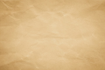 Brown background paper, crumpled texture and watercolor. Old vintage page with a glowing center and grunge vignette.