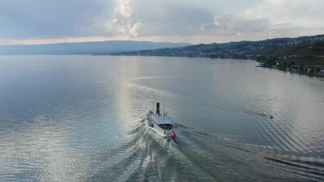 Aerial shot following Belle-Epoque steam boat on Lake L&radic;&copy;man in front of Cully, Lavaux - Switzerland
Mirror-like water and storm-clouds in the background