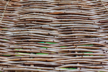 Close up wicker fence in the garden.