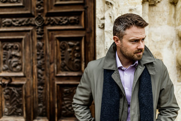 dapper man outside a building