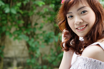 Young pretty Asian woman with flower headband.