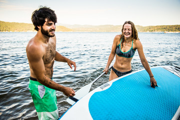 Young beautiful couple playing in a lake.