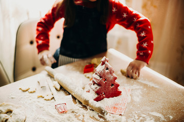 Crop girl at messy table making cookies