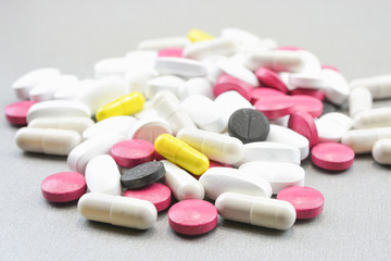 A bunch of colorful pills on a gray background.Medical topic  