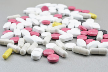 A bunch of colorful pills on a gray background.Medical topic  