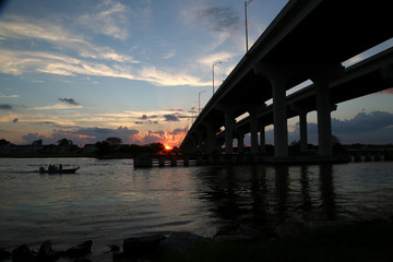 Fototapeta na wymiar Bridge and Boat in Silhouette
