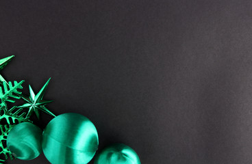 A green decoration for a Christmas day with a black backdrop.