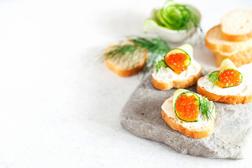 Sandwich with ricotta, a cucumber, caviar .