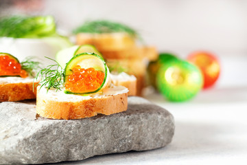 Sandwich with ricotta, a cucumber, caviar .