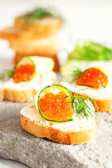 Sandwich with ricotta, a cucumber, caviar .