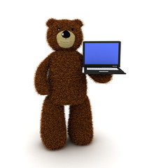 Toy teddy bear and laptop
