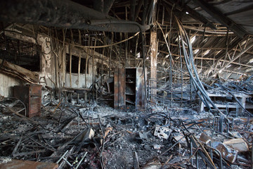 Fototapeta na wymiar Interior of a factory damaged by fire / Damage caused by fire - Burnt interior