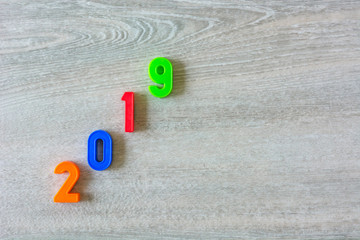 Happy New Year 2019 written with colorful plastic numbers.