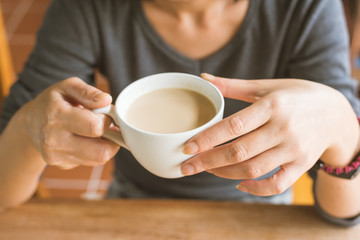 woman hold a cup a coffee