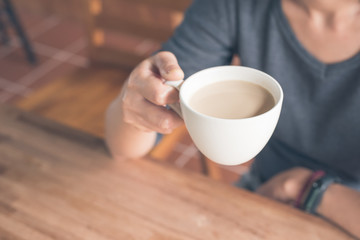 woman hold a cup a coffee