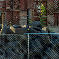 Pile of discarded black tires on a sunny day