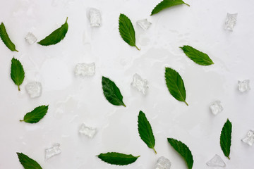 background of fresh mint leaves and ice. Flat lay, top view.