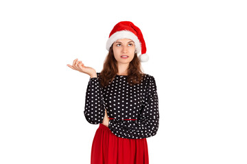 Portrait of attractive woman pointing up with index finger. emotional girl in santa claus christmas hat isolated on white background. holiday concept