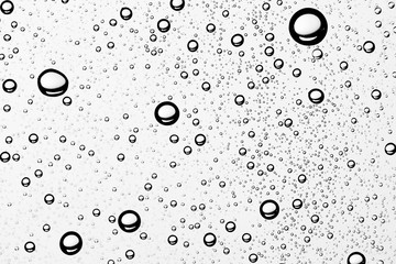 white isolated background water drops on the glass / wet window glass with splashes and drops of water and lime, texture autumn background