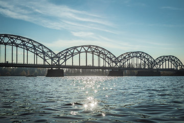 Railway bridge in Riga over the Daugava River in the fall in October on a sunny day