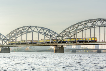 Railway bridge in Riga over the Daugava River in the fall in October on a sunny day