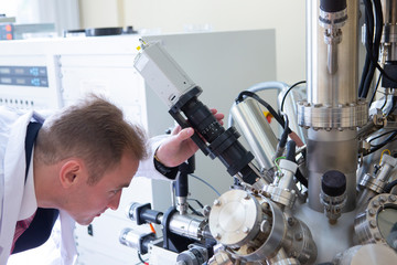 laboratory specialist examines the data obtained on a special apparatus for analyzing samples