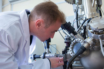 laboratory specialist examines the data obtained on a special apparatus for analyzing samples