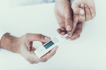 Doctor Taking Blood Sample from Boy's Finger.