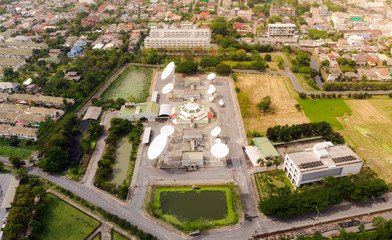 Bird's-eye view from drone of Satellite Dish, Satellite communication and satellite dish at Daytime city background / Plains - Telecommunication tower Antenna