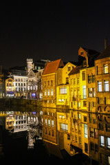 Night view of the old town and reflection in the river in the city of Ghent Belgium