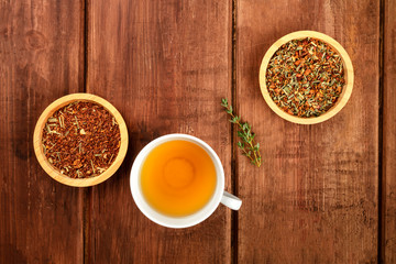 An overhead photo of herbal tea on a dark rustic background with copy space