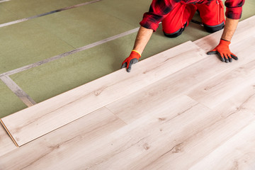 Handyman installing wooden floor

