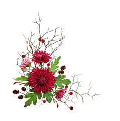 Purple chrysanthemum flowers and autumn dry twigs in a corner arrangement